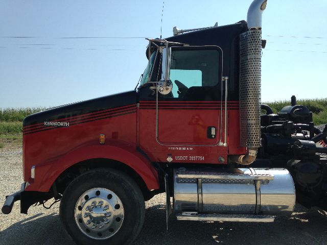 Kenworth T800 conventional daycab truck side profile showing red and black cab, chrome fuel tank, and exhaust stack.