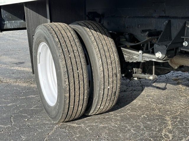 Truck rear dual tires on a Ford F-550 chassis showing wheel rims and suspension components.