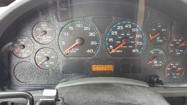 Dashboard of a 2007 International 8600 truck showing gauges including tachometer, speedometer, fuel, oil pressure, and an odometer reading 242,957 miles.