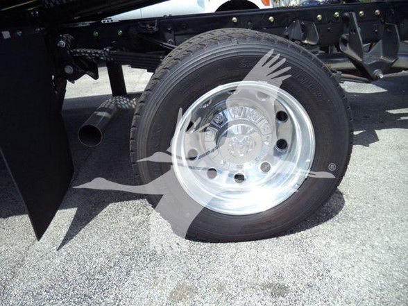 Ram 5500 front wheel and tire assembly with steel rim and hub cap, undercarriage visible.
