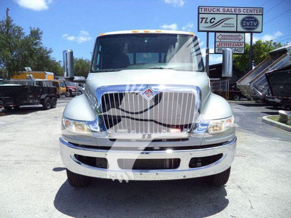 Front view of a 2022 International MV tow truck with chrome grille and large bumper.