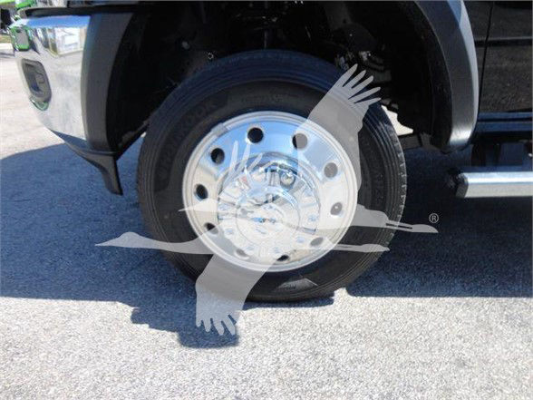 Wheel and hub of a Ram 5500 truck front wheel with steel rim and tire, partial fender and step bar visible.
