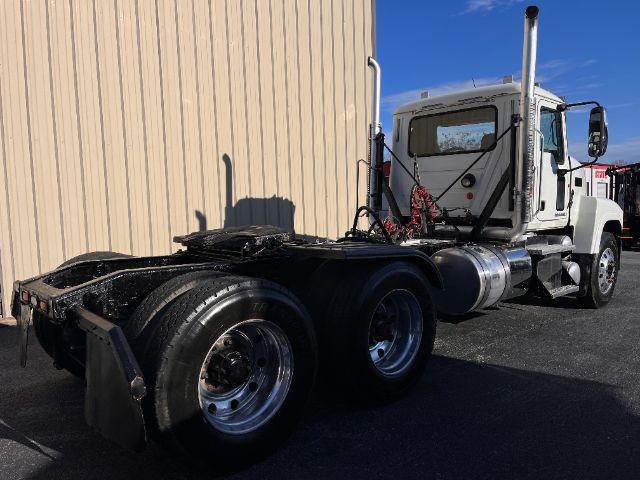 Truck chassis of a 2013 Mack CHU613 Pinnacle without trailer, showing the cab, exhaust stacks, fuel tanks, and rear dual wheels.