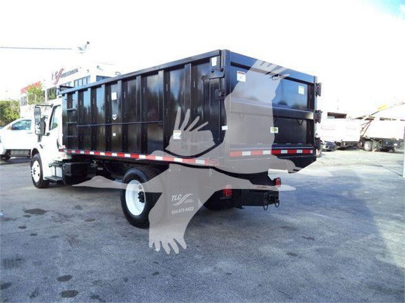 Dump truck rear and side view showing black dump bed, white cab, and red reflective tape along the sides.