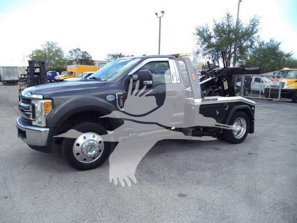 Ford F-450 tow truck side view showing dual rear wheels and flatbed with equipment, watermark across image.