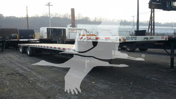 Doonan Combo Drop trailer in yard showing flatbed with serial number 53-5712 and long deck.