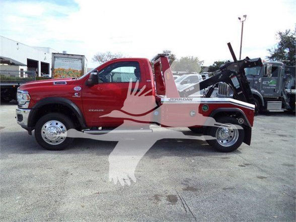 Tow truck body: red 2024 Ram 4500 SLT with flatbed and equipment, side view showing single cab, chrome wheels, Ram badge, Tow status.