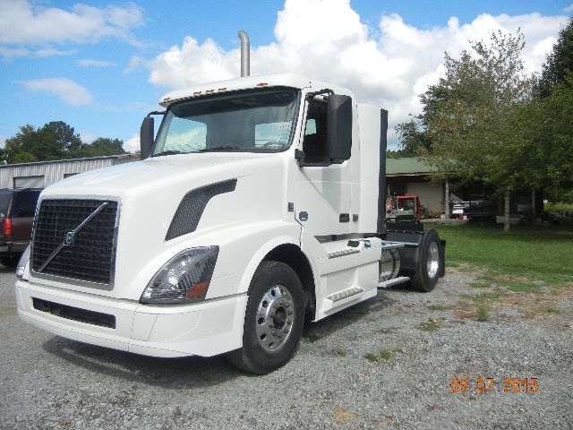 White Volvo VNL 42300 cab and chassis truck in an outdoor lot, side view with sleeperless cab, date stamp 09 07 2015.