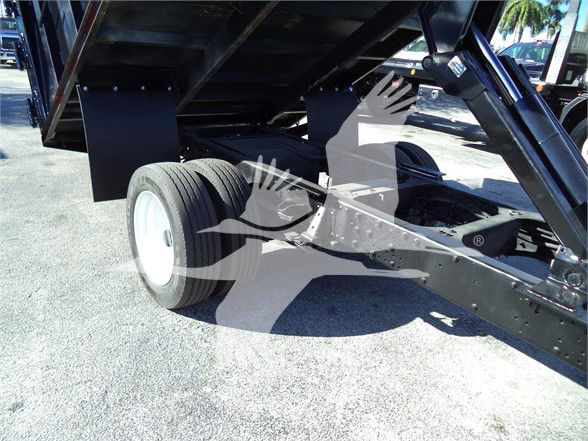 Isuzu NRR dump truck chassis showing rear wheel and dump bed frame.