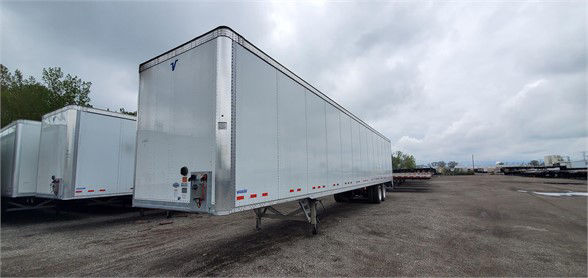Vanguard VXP dry van trailer in a lot with other trailers, aluminum skin, rear doors, and reflective tape.