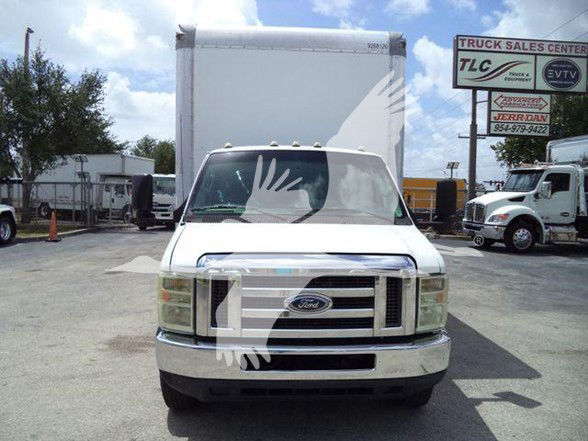 Ford E-Series work box truck front view with large box body and Ford emblem on grille. Text visible: none specific on image captions aside from generic signage in background.