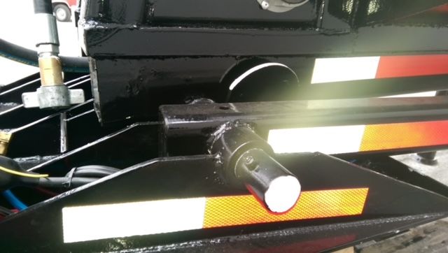 Trailer hitch and underside of a 2009 Great Dane 40 ft dump trailer showing hitch mechanism and reflective tape.
