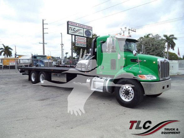 2006 Peterbilt 348 tow truck in green with flatbed, side view showing cab and front wheels, TLC truck & equipment watermark