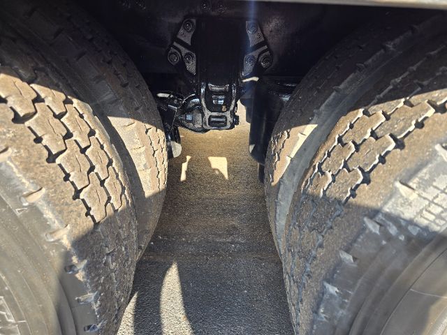 Peterbilt 348 rollback truck rear view showing dual rear axles and tires.
