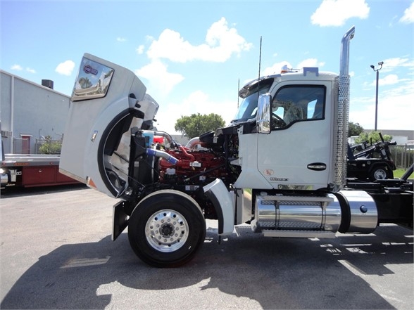 Kenworth W900 truck cab with exposed engine showing components.