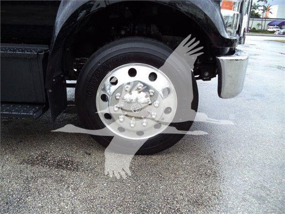 Wheel and front fender of a 2024 Ford F750 SD truck showing a polished aluminum wheel and tire with hub details.