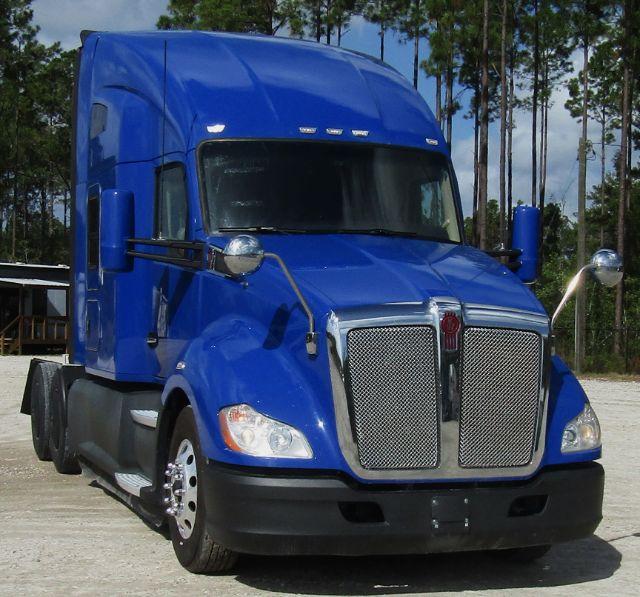 Kenworth T680 semi-truck cab and chassis in blue, front view, with large chrome grille and blue cab, stock number 371231.