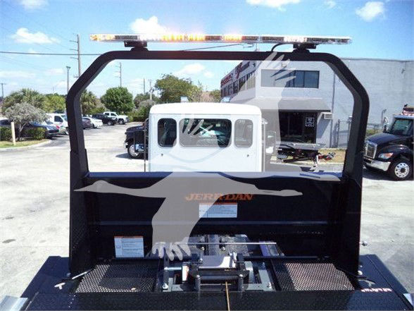 Kenworth T280 utility truck bed with rear frame and warning light bar, visible tail end and towing equipment.