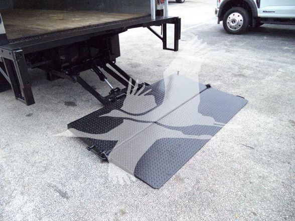 Isuzu NPR HD truck with a lowered wheelchair/step platform near the back of the box truck.