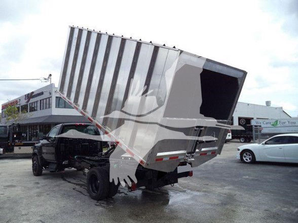 Truck chassis with a large tilt dump bed raised, Chevrolet Silverado 6500HD style dump body on a heavy duty chassis.