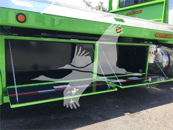 Green Peterbilt 337 truck with open side compartments and jerry-joint ladder, storage boxes visible under the cab, tow category image.