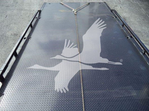 Flatbed truck bed with a large printed eagle graphic. No other legible text visible.