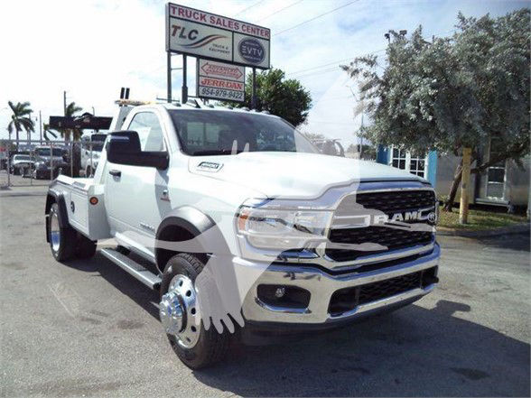 2023 Ram 4500 SLT truck in a dealership lot, front three-quarter view showing chrome grille, dual rear wheels, large side mirrors, and tow equipment. VIN and stock not visible on image.