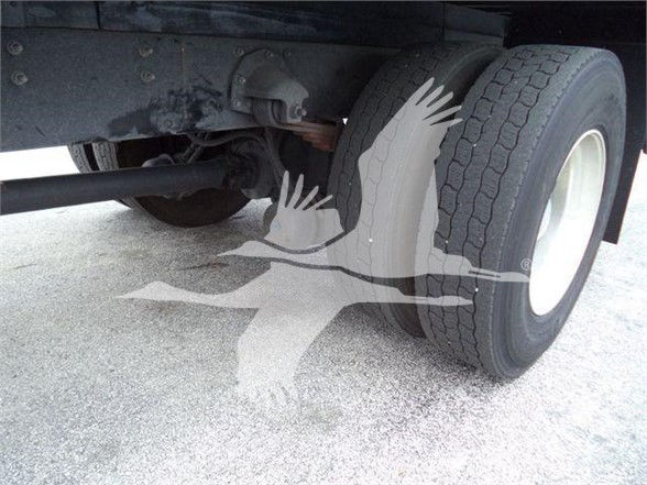 MD7 truck axle close-up showing dual rear wheels and suspension undercarriage.