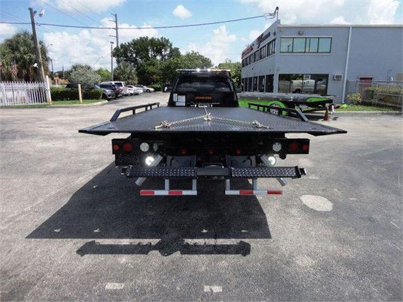 Ram 5500 tow truck flatbed rear view showing lights and safety reflectors.