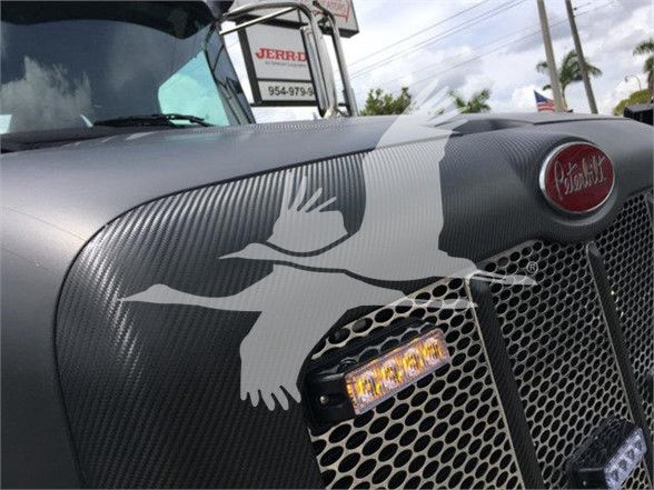 Peterbilt 337 truck front grille with decorative graphics, close-up of hood and grill.