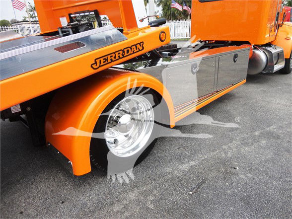 Peterbilt 337 orange tow truck side view with chrome wheels and JerrDan conveyor equipment visible.