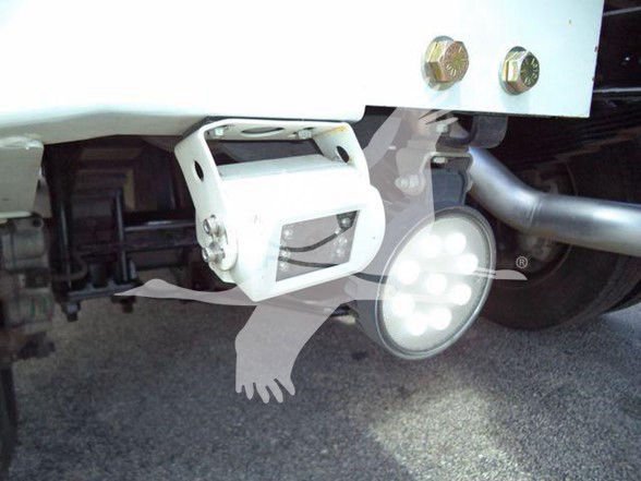 Rear view of a 2023 Ram 4500 SLT tow truck showing a white bumper hitch receiver and a circular LED backup light.