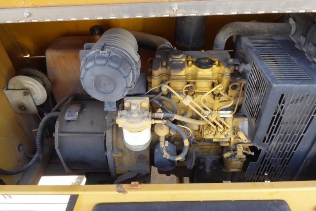 Allmand Night Lite Pro equipment engine bay with diesel engine, air filter, and electrical components visible.