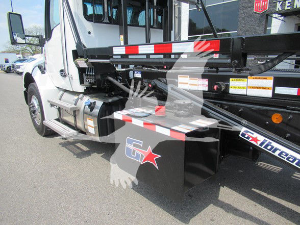Kenworth T480 refuse truck chassis showing side toolbox and hydraulic lines