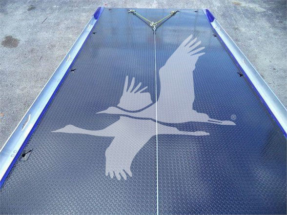 Flatbed trailer deck with Diamond plate surface and a large white eagle graphic in flight.