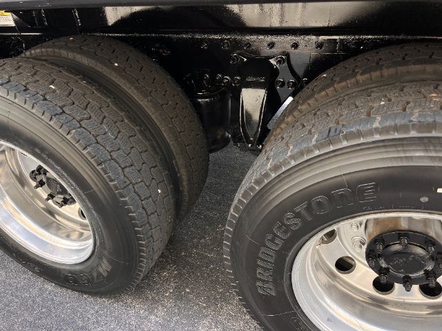 Dual rear wheel setup on a Freightliner Cascadia truck chassis showing Bridgestone tires and dual axle configuration.