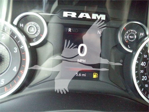 Ram dashboard showing 0 mph, 5.6 mi range, and fuel icon with RAM branding in center cluster.