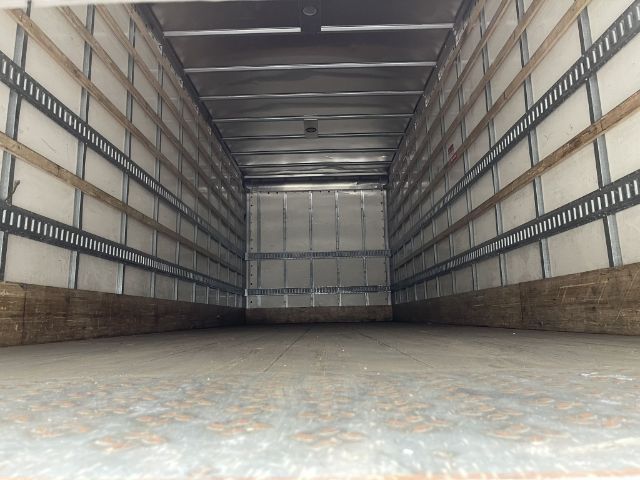 Box truck cargo area showing empty interior with metal side walls and tiedown rails.