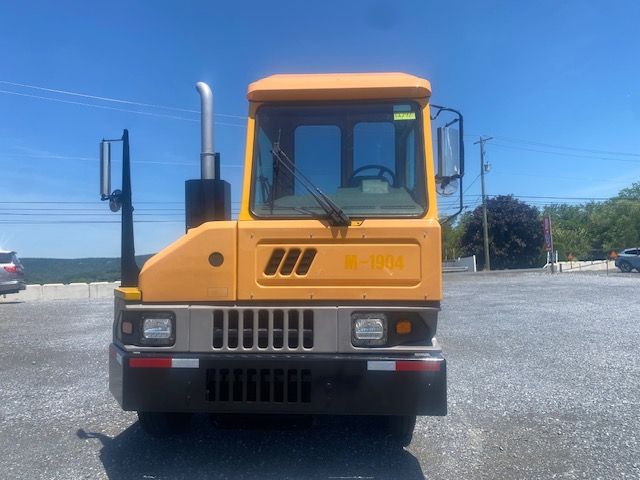 Front view of a yellow 2017 Ottawa T2 yard truck with cab and grille, windshield wipers, and side mirrors visible.