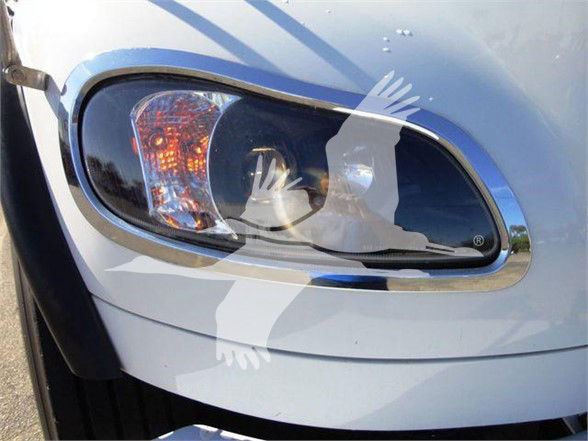 Headlight area of Freightliner business class M2 106 showing front bumper and headlamp with image watermark.