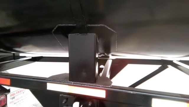 Underneath a Great Dane 40 ft round bottom dump trailer showing frame and support bracket.