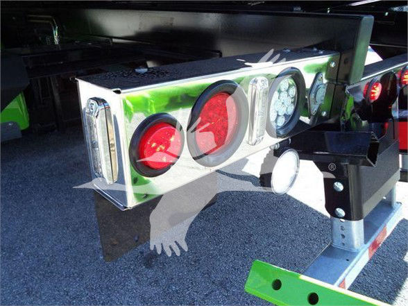 Rear view of a Kenworth T280 tow truck bumper with multiple round taillights in red and white, and reflective surfaces.