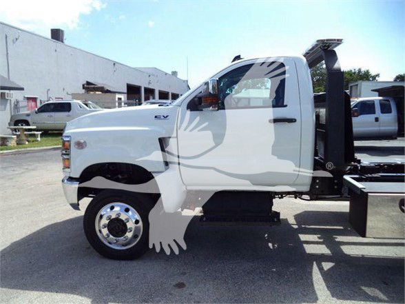 Truck cab side view showing CV wheel and chassis with tow setup and ‘EV’ badge on door.