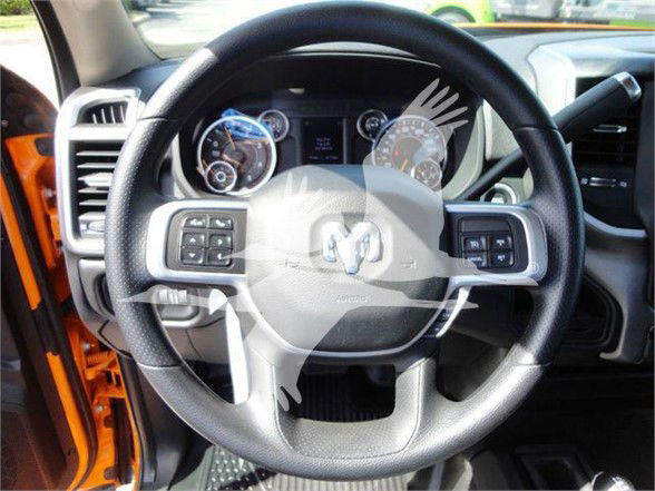 Ram steering wheel with multi-function controls and instrument cluster in dashboard of a 2024 Ram 4500 SLT truck interior.