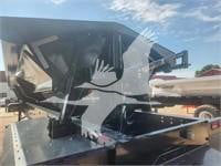 Dump trailer hitch area showing structural frame, mounting brackets, and metal support beams.