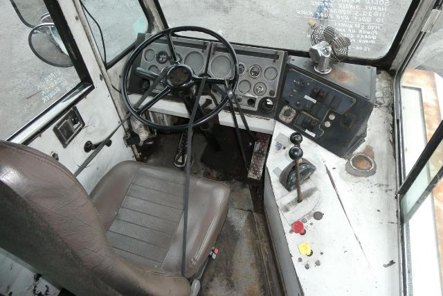 TJ5000 yard truck cab interior showing steering wheel, dashboard gauges, and control levers.