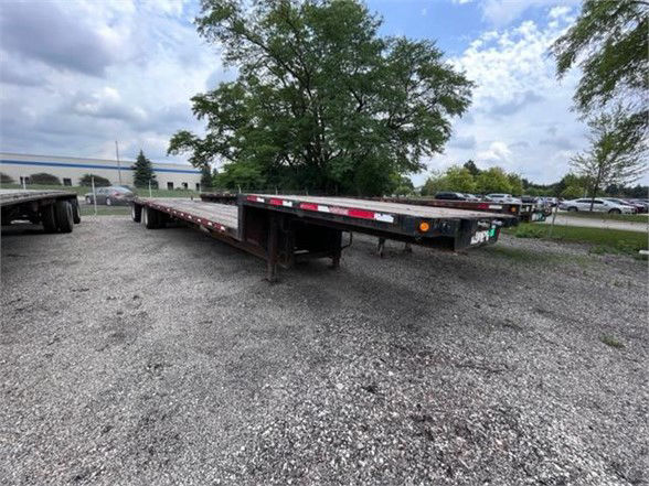 2006 Fontaine ELITE drop deck trailer showing long flat platform with undercarriage and lights, stock number 54473 ELI visible.