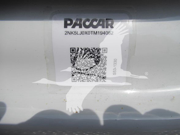 Paccar label with VIN and stock number on a white surface. Text reads: PACCAR, 2NK5LJ0X0TM194082, QR code, 555-1330 (vertical).