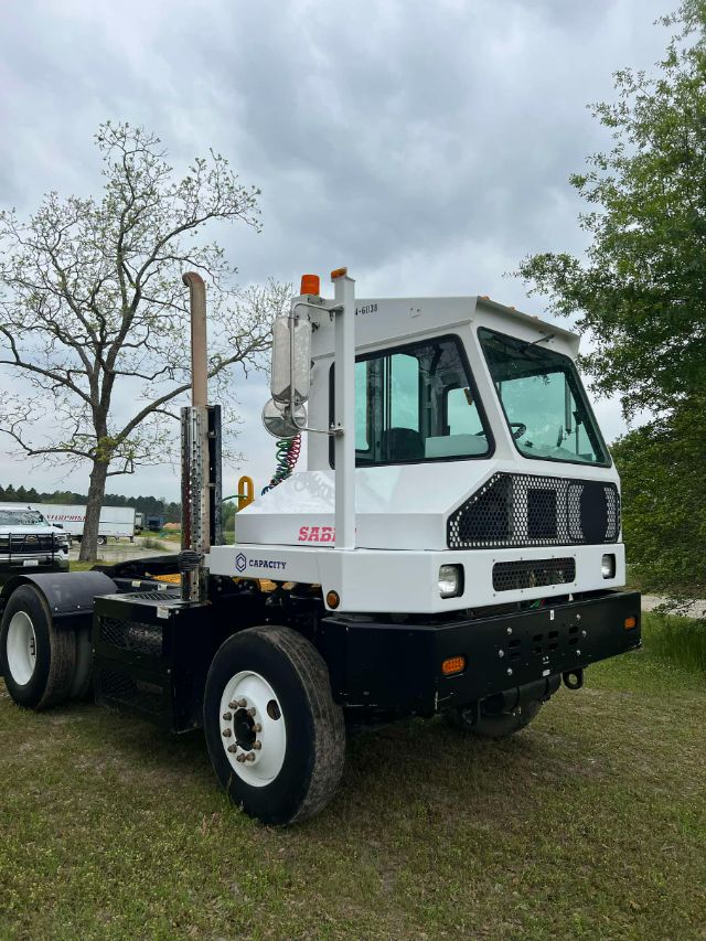 Capacity TJ 5000 yard truck with white cab and black chassis, visible tires, and a vertical exhaust stack.