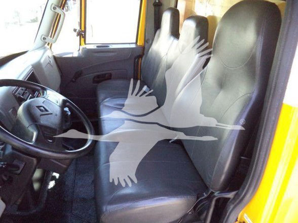 Cab interior of a 2019 International DURASTAR 4300 showing front bench seats and steering wheel.